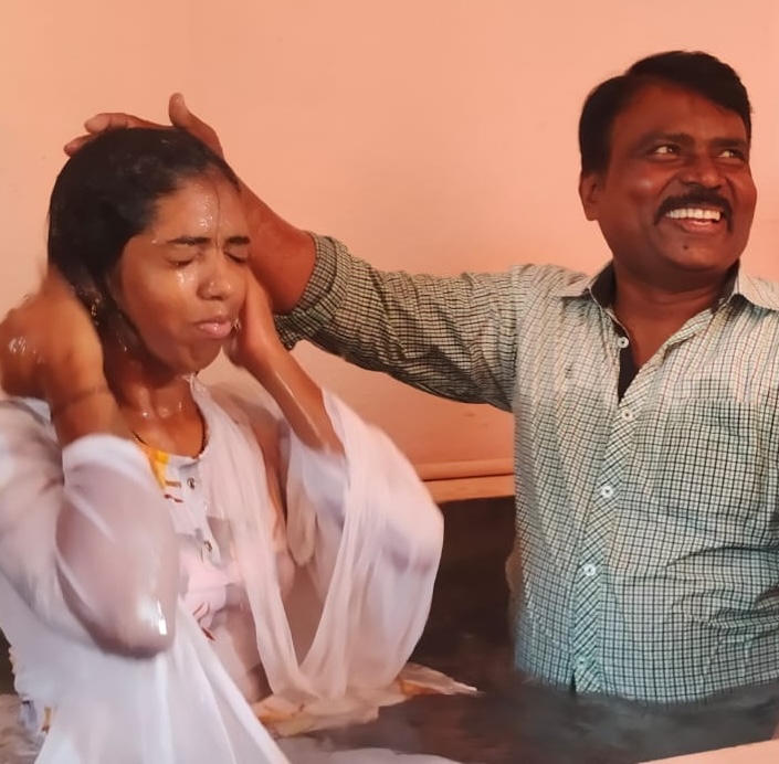 A CSM pastor baptizing a young woman